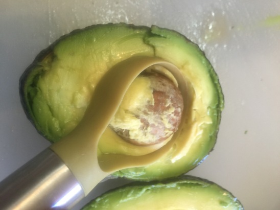 Pitting the avocado.